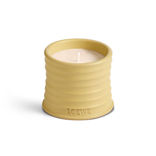 beauty Valentine’s gifts: a small, yellow honeysuckle-scented candle by LOEWE on a white background