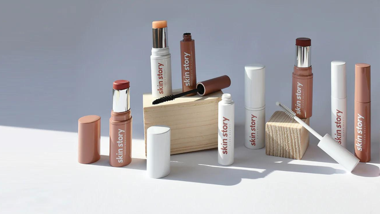 Skin Story products sit in a still-life arrangement using wooden plinths on a grey background