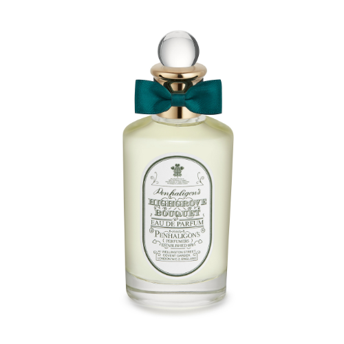 A packshot of the PENHALIGON’S Eau de Parfum Highgrove Bouquet. The product is cut out against a white background. The bottle has a green bow on the lid and writing on the front. It looks to be made of glass.