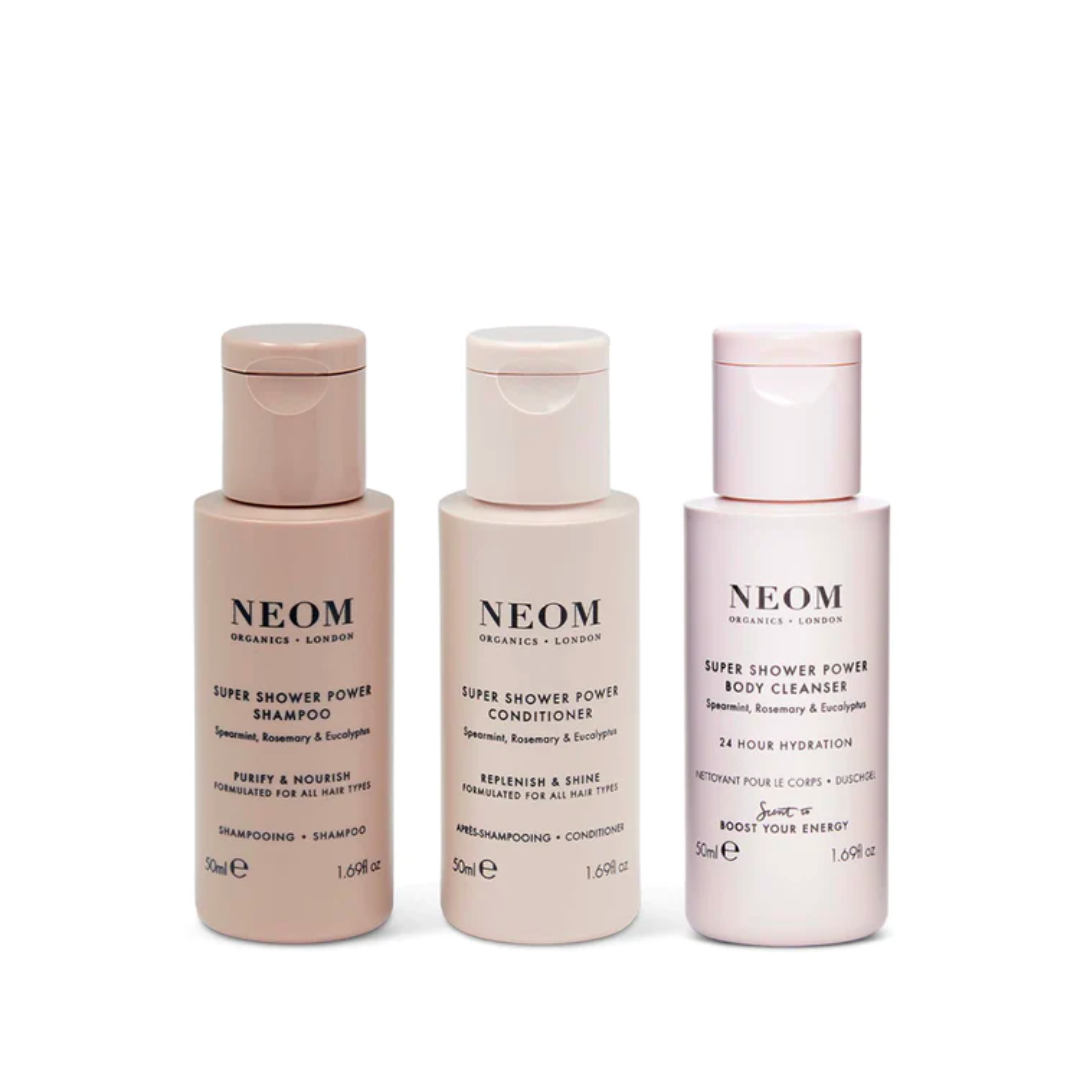 Beauty travel kits: a trio of NEOM shower essentials, including a shampoo, conditioner and body cleanser