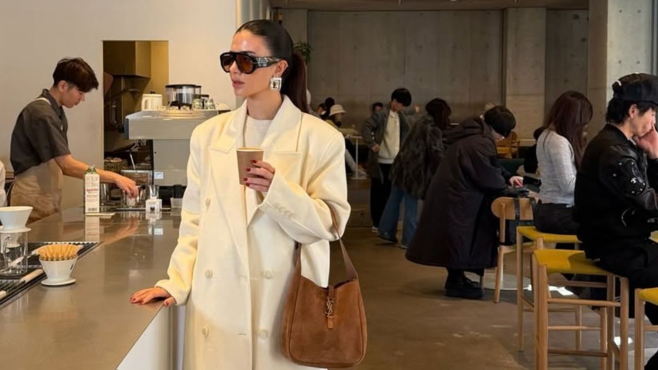 @deemaalsadi holding a coffee