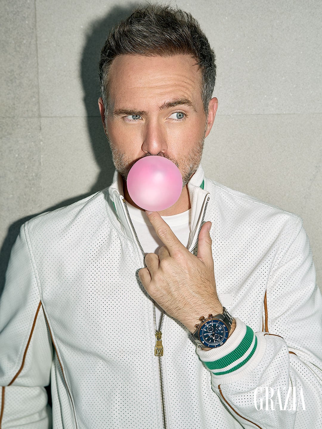 Erik Hayser posando con una bomba de chicle para Grazia Men 2026