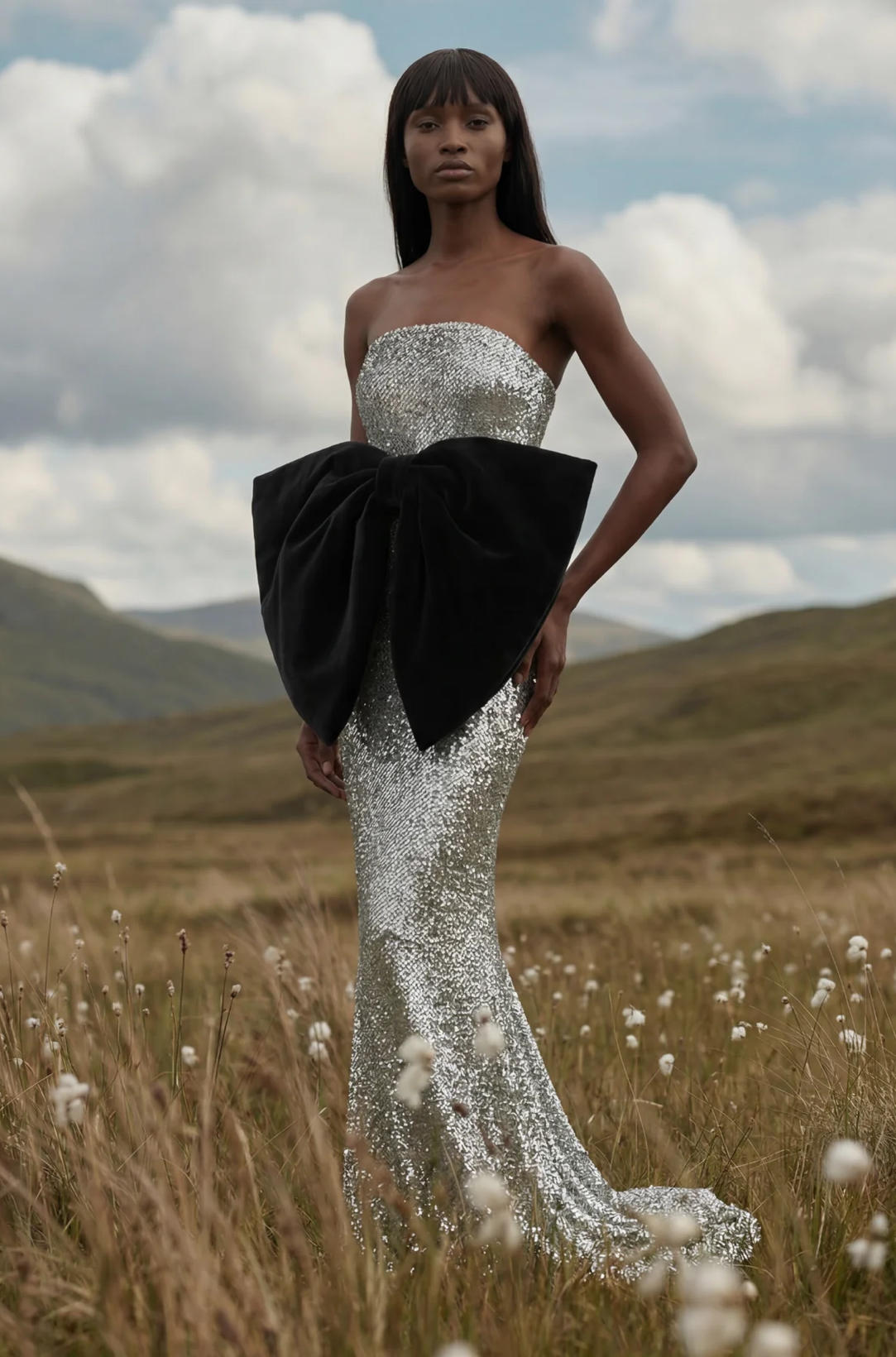 Black bow on a silver sequin dress