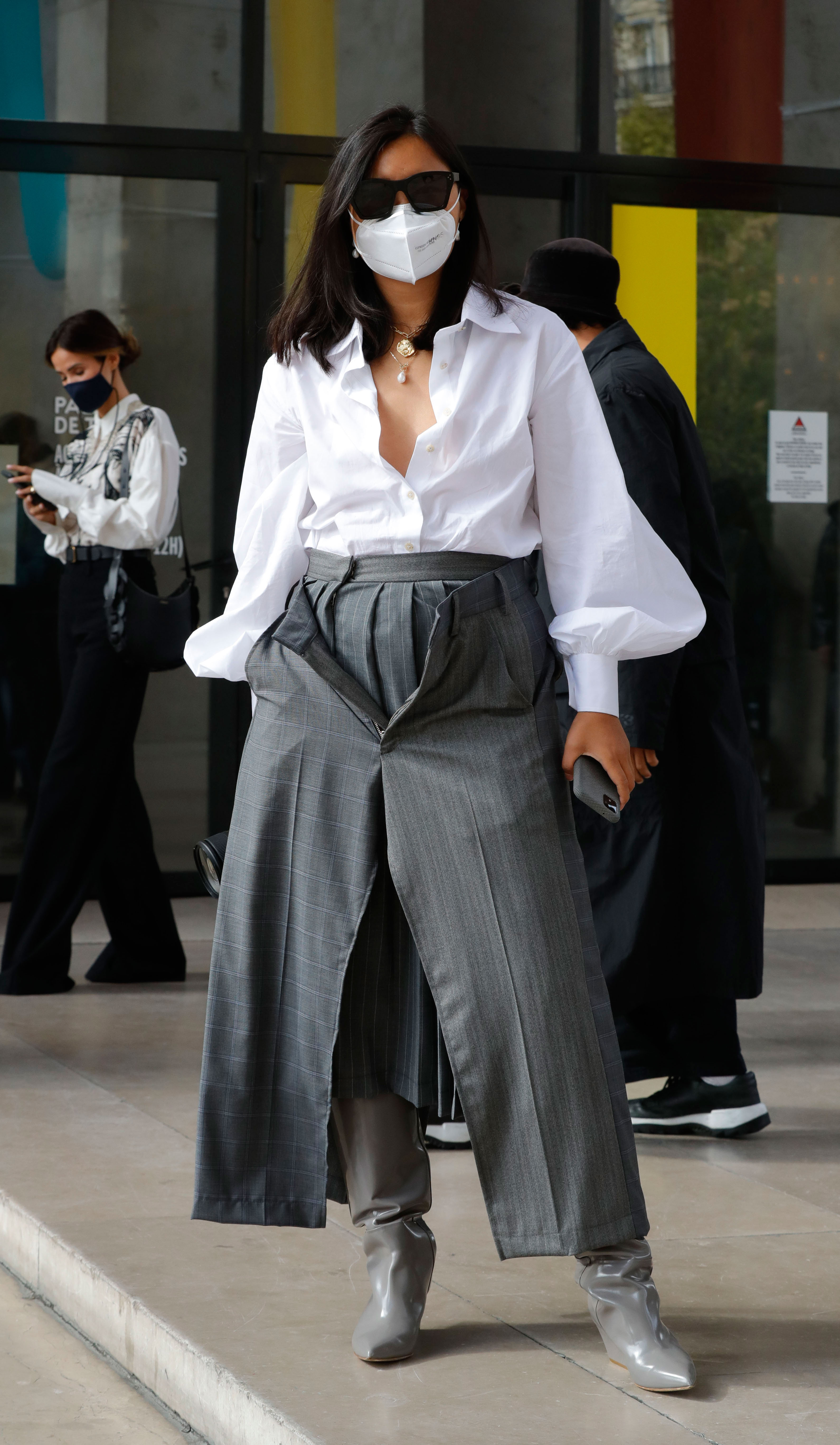 Paris Fashion Week Street Style: Woman in grey culottes, a white blouse, and a matching mask. 