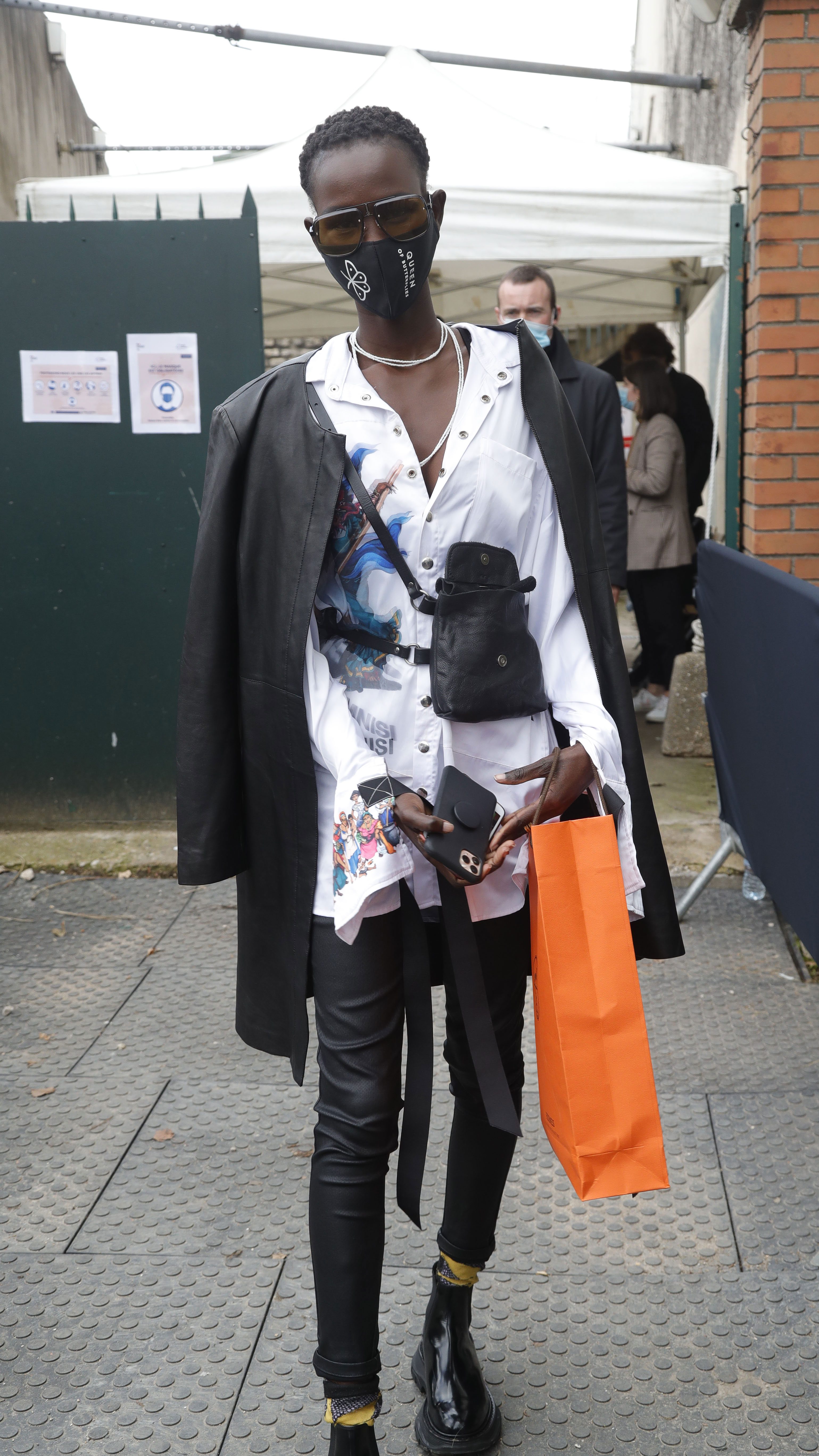 Paris Fashion Week Street Style: Woman in a mask and a black-and-white ensemble.