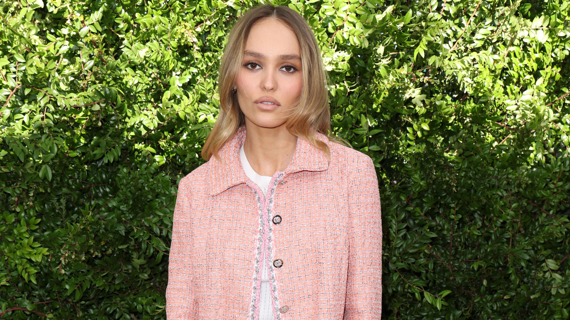 Lily-Rose Depp shows off her long legs under a tiny black dress.
