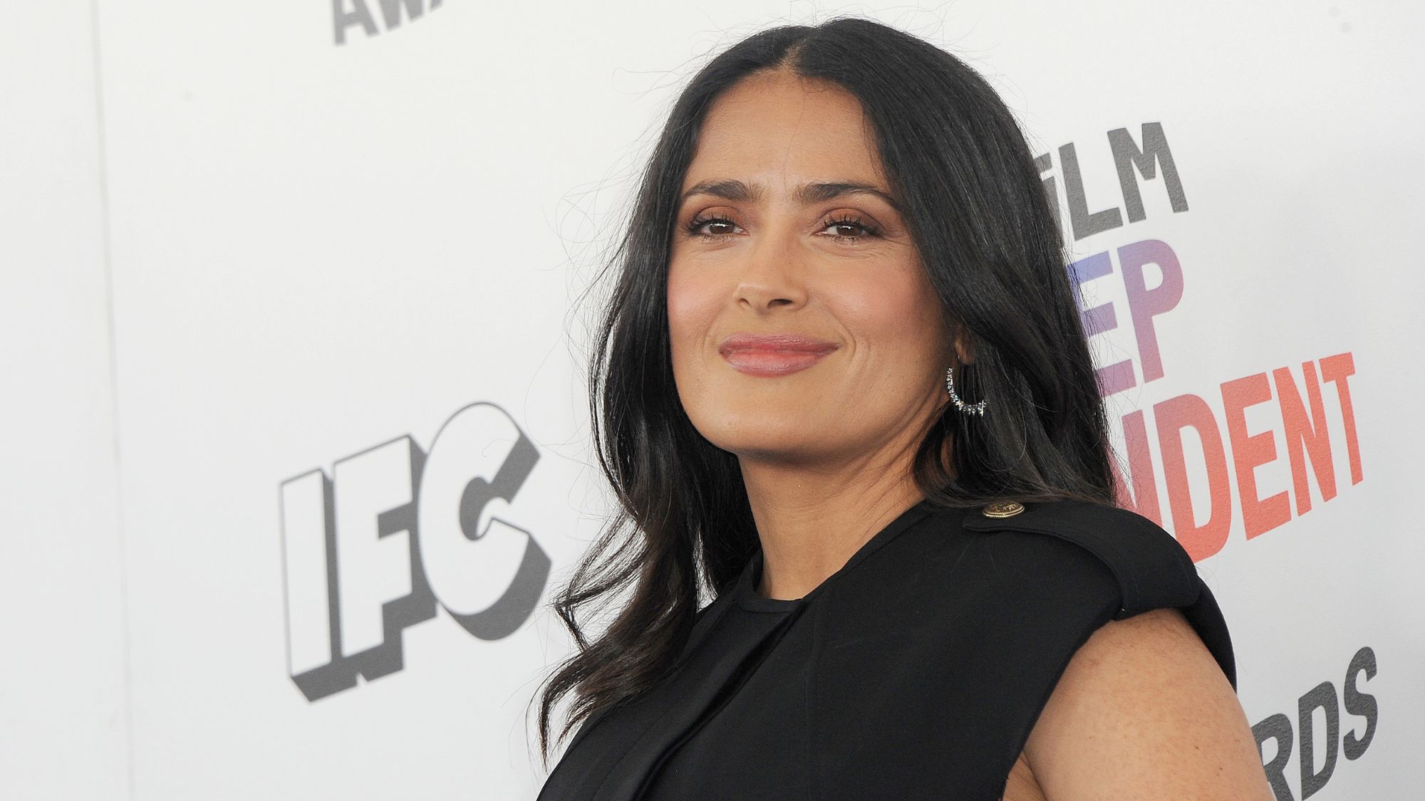 Salma Hayek stuns in a yellow bikini, showing off her curves and playfully joking about her gray hair.
