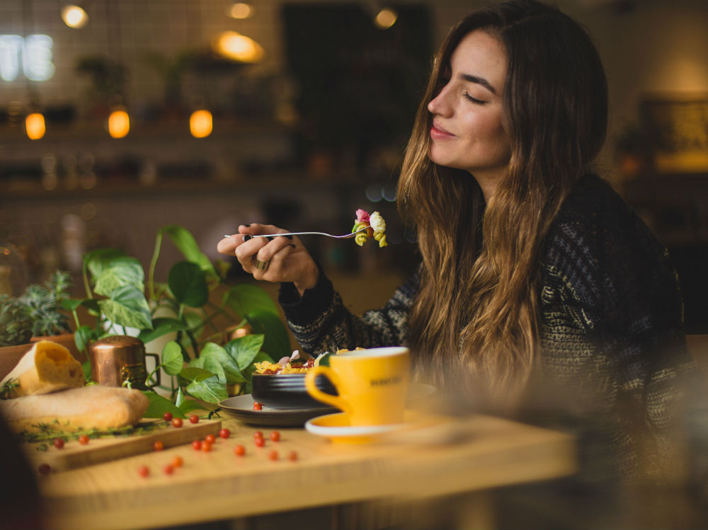 woman-eating-with-tea-smiling