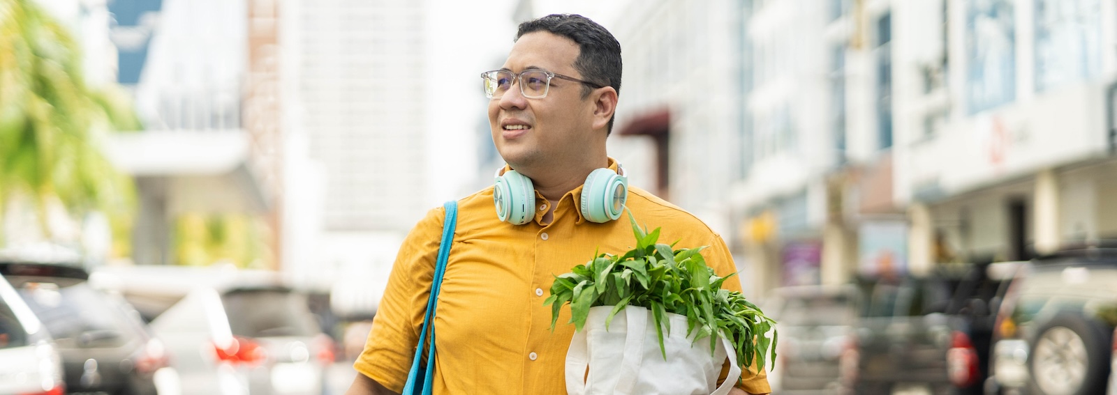 Getty-Images-Asian-man-walking on-street-with groceries-on-hands-habit