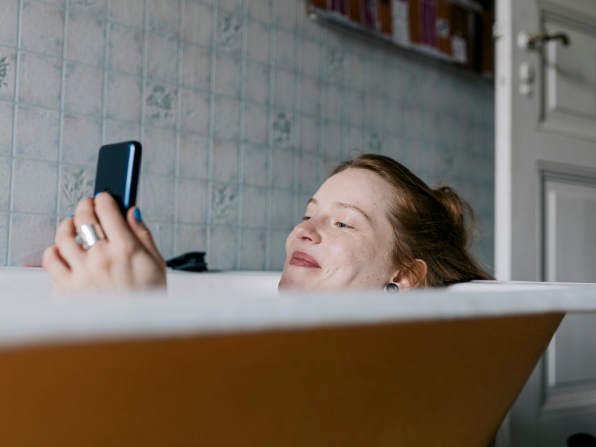 dating-app-woman-using-phone-in-a-bathtub