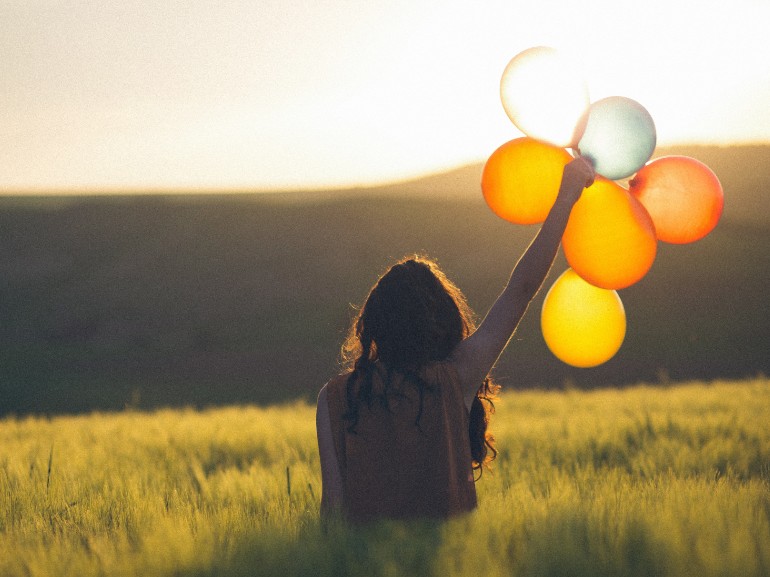 kindness-someone-holding-colorful-balloons