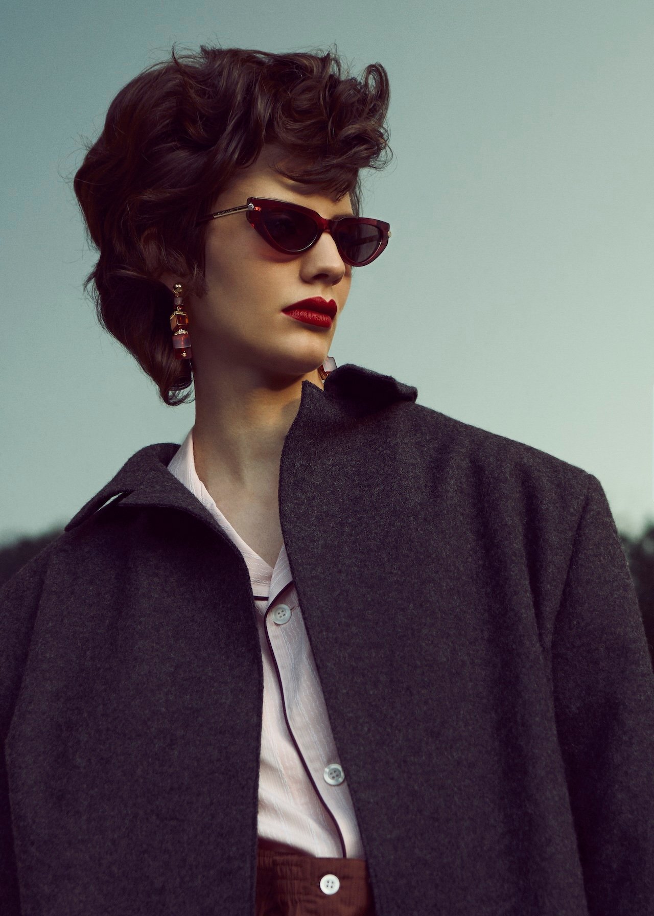 Prada coat, shirt, earrings, prada.com; McQueen sunglasses, alexandermcqueen.com.