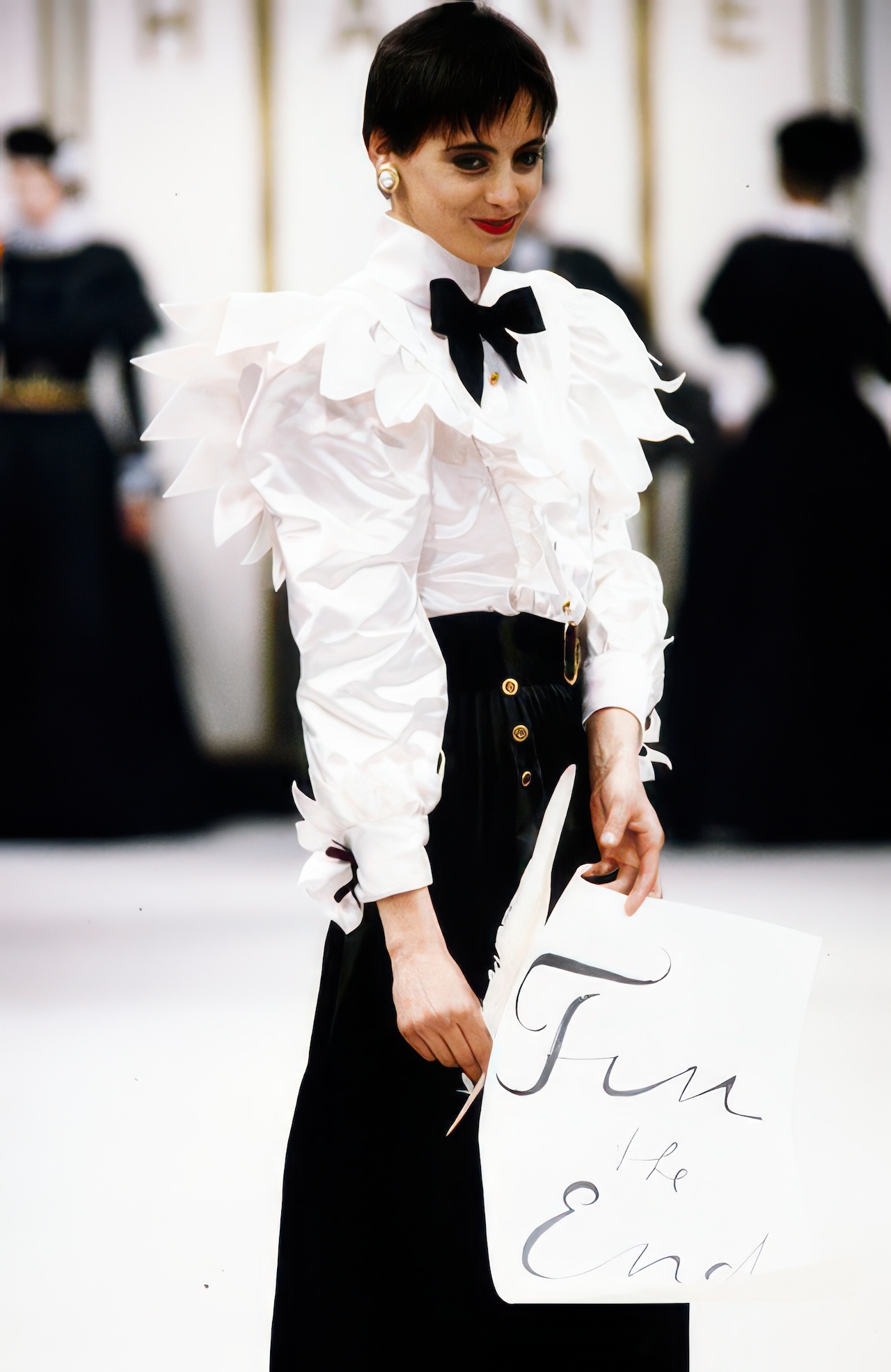 Ines de La Fressange in a white satin George Sand top in the Fall/Winter 1984 Chanel “George Sand” RTW collection © Getty Images