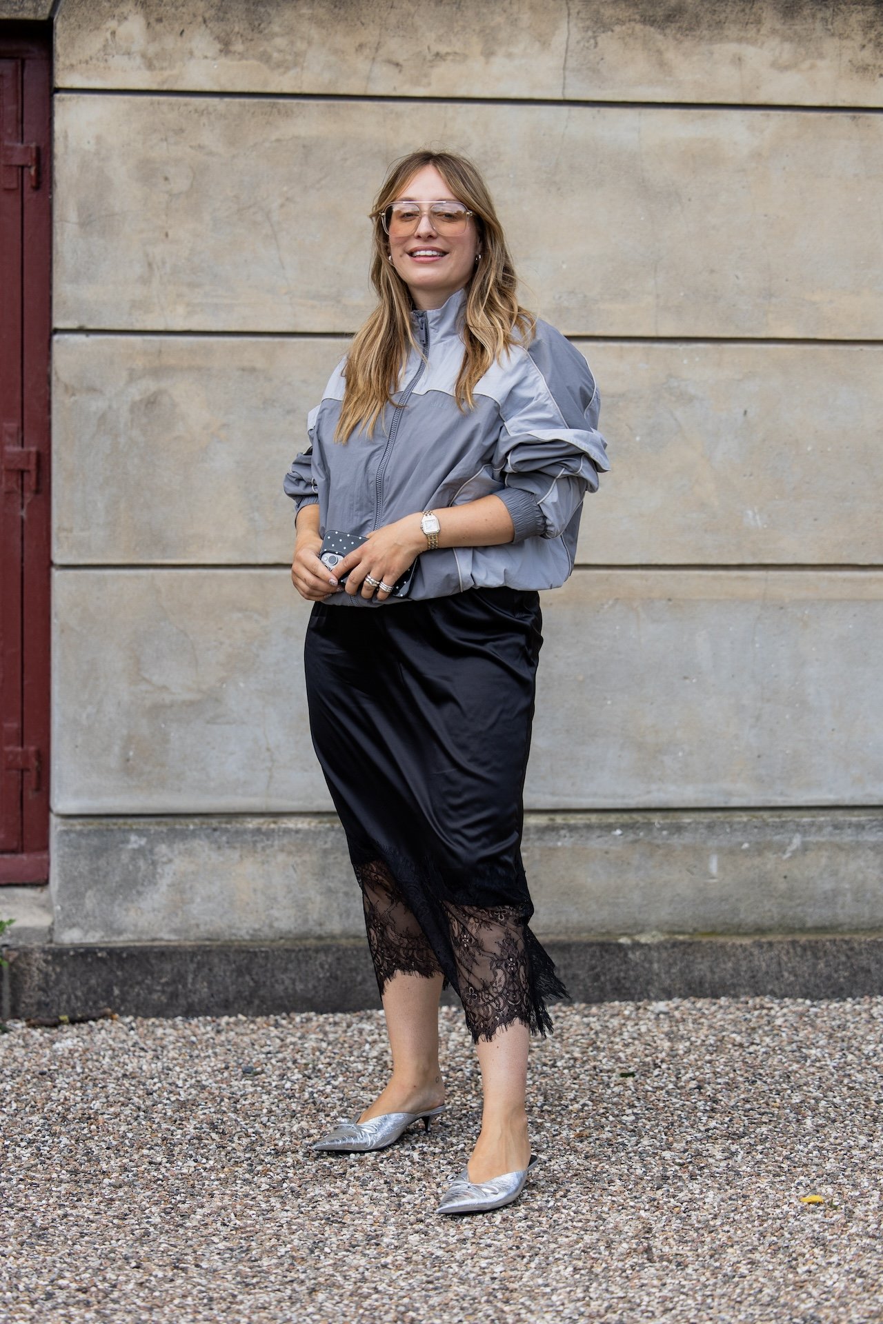 Yara Michels wears grey zipper jacket, black laced skirt outside Munthe during Copenhagen Fashion Week