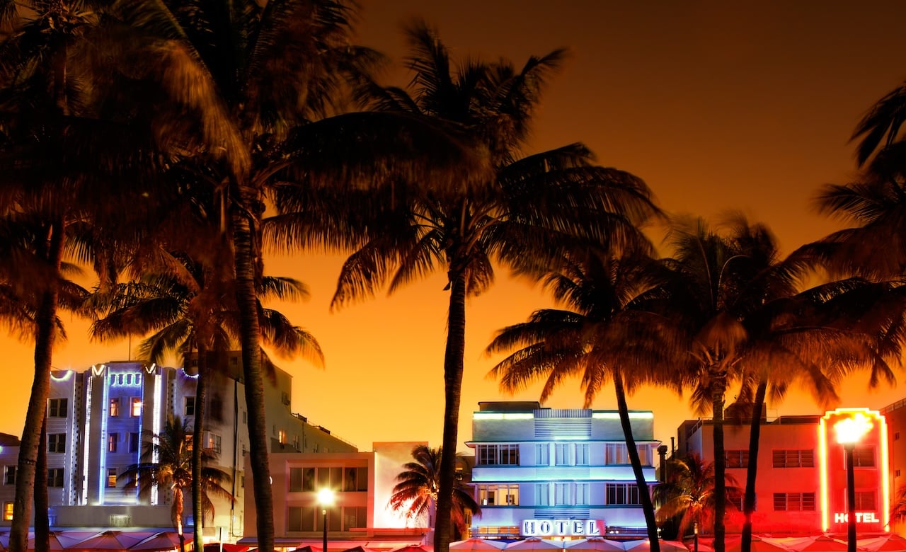 view of art deco hotels and restaurants on Ocean Drive, South Beach, Miami, Florida during sunset