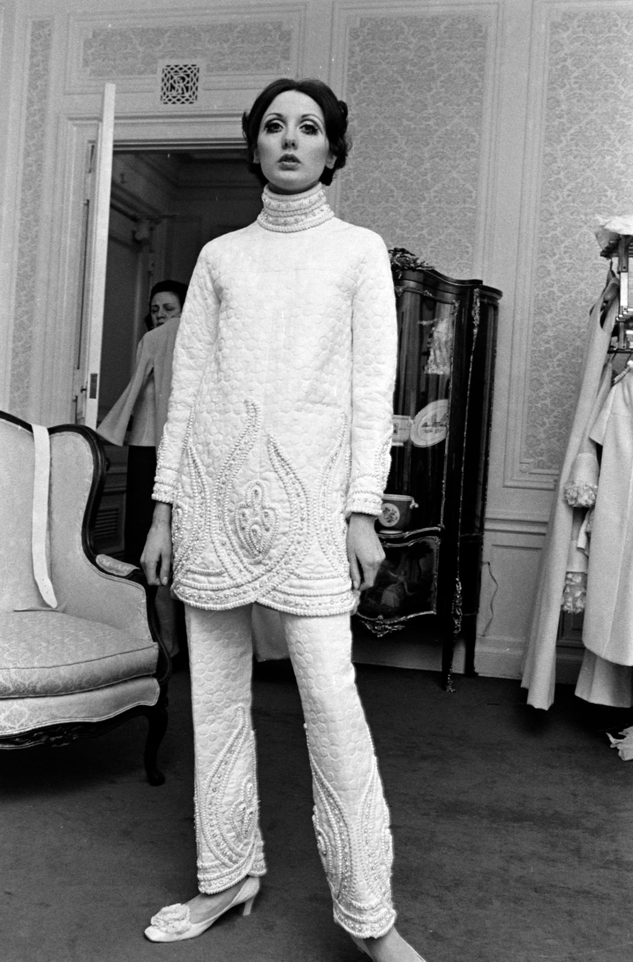 Valentino ‘White Collection’ 1968; A model poses in a quilted and embellished tunic and pants from Valentino’s spring 1968 haute couture “White Collection” at the St. Regis Hotel in New York on March 11, 1968. Photo Credit: FAIRCHILD ARCHIVE/WWD
