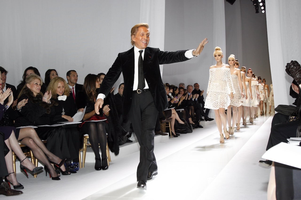 PARIS- JANUARY 22: Italian fashion designer Valentino waves as he walks on the catwalk at the Valentino Fashion show, during Paris Fashion Week Haute Couture Spring-Summer 2007 at Beaux Arts on January 22, 2007 in Paris, France. (Photo by Michel Dufour/WireImage)