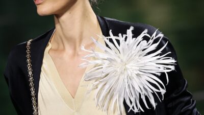 A model presents a brooch by Chanel for the Women Ready-to-wear Spring-Summer 2026 collection as part of the Paris Fashion Week, at the Grand Palais, in Paris, on October 6, 2025. (Photo by Anne-Christine POUJOULAT / AFP)