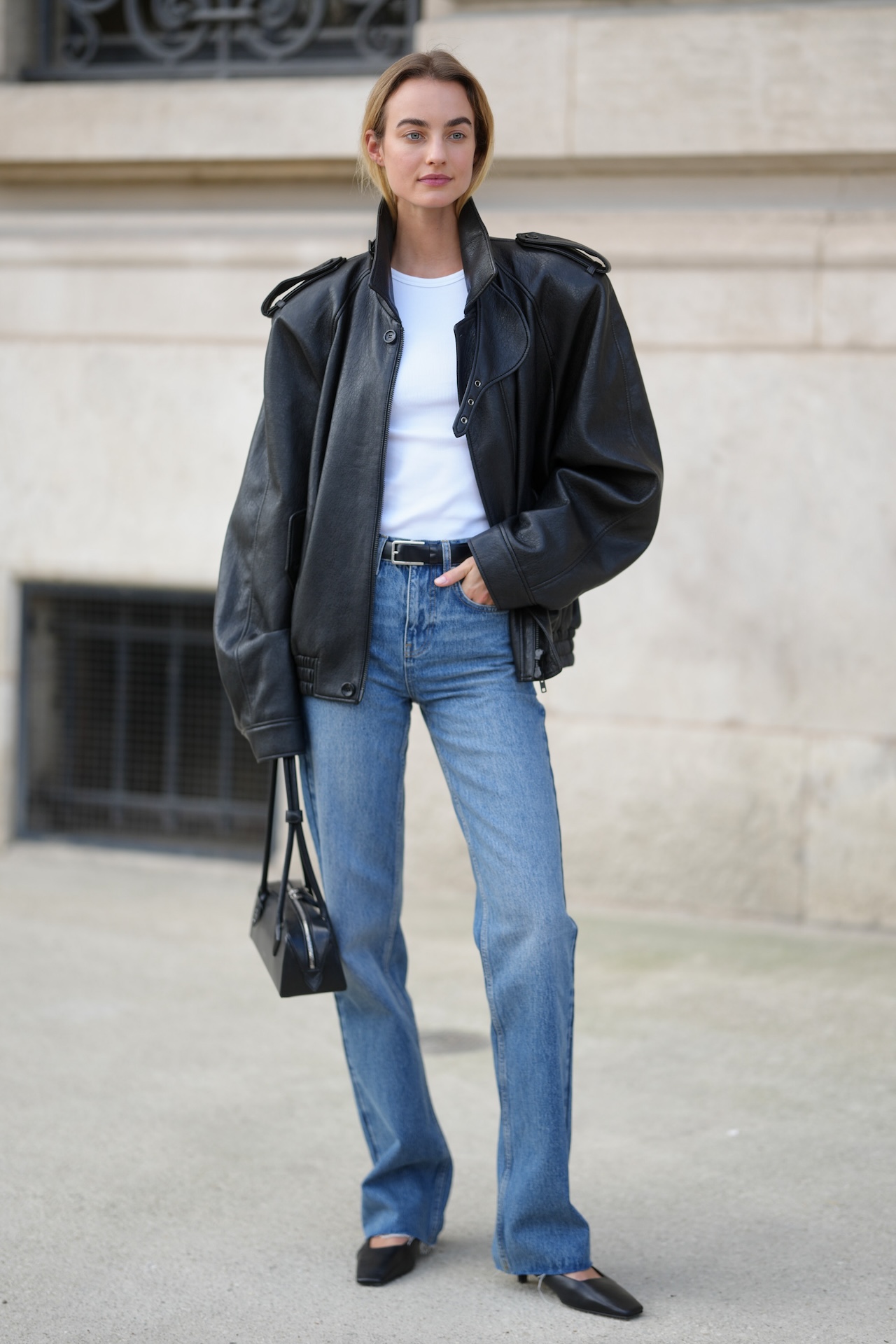 PARIS, FRANCE - MARCH 09: Maartje Verhoef is seen wearing black cat-eye sunglasses, a black leather bomber jacket with shoulder epaulets, a white crew-neck t-shirt, a black leather belt with a silver buckle, blue straight-leg denim jeans, black pointed-toe leather flats, while carrying a black leather top-handle bag during Day Eight of Paris Fashion Week - Womenswear Fall/Winter 2026/2027 on March 09, 2026 in Paris, France. (Photo by 305pics/Getty Images)