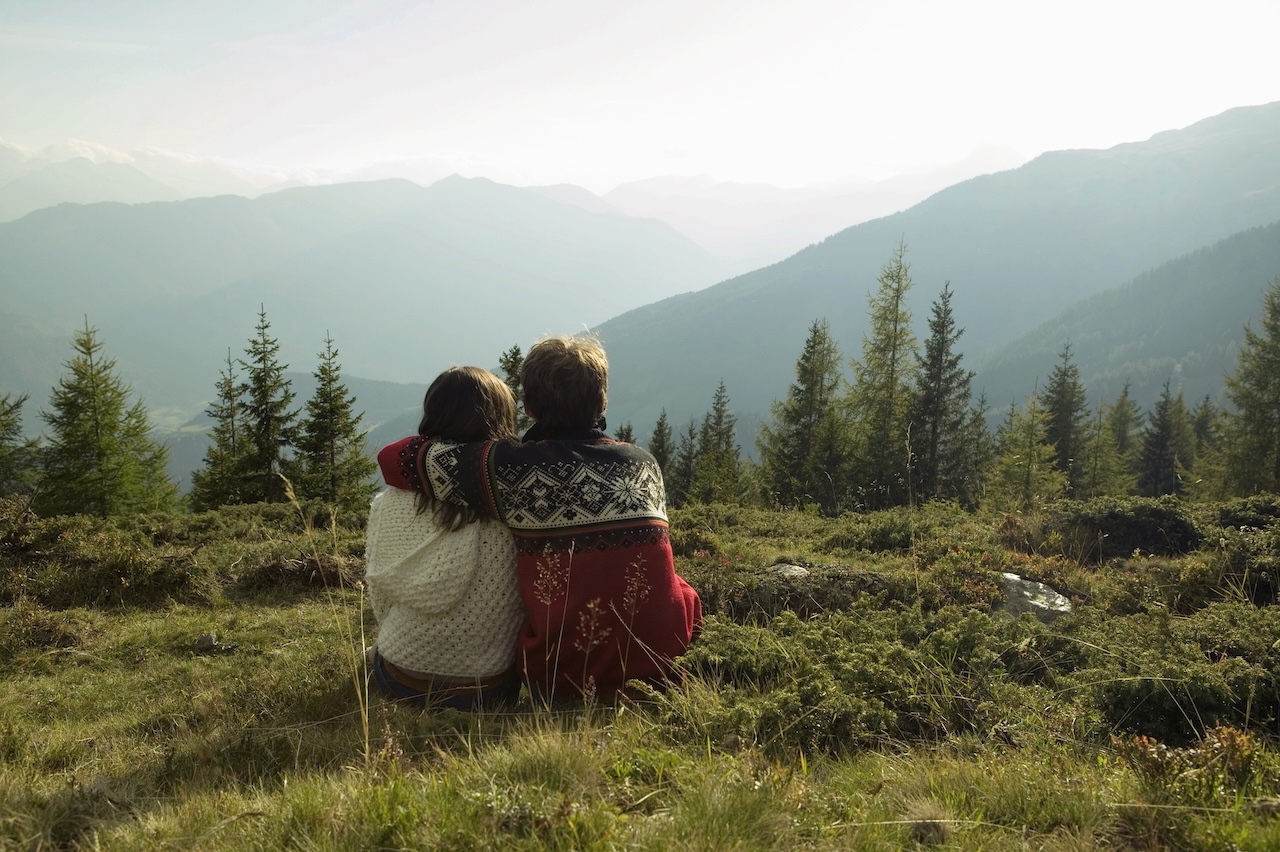 Young couple sitting in mountains