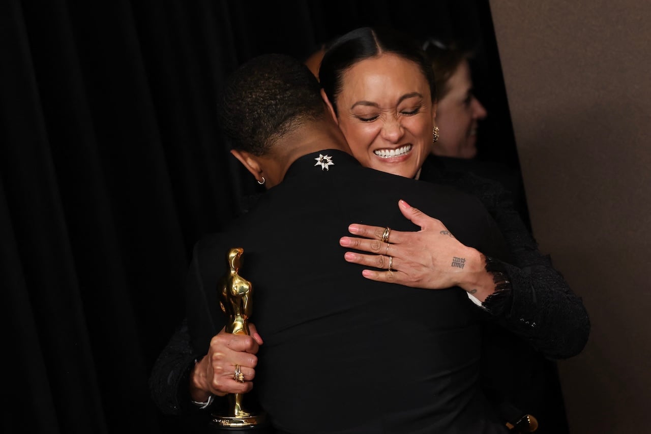 (L/R) US actor Michael B. Jordan, Oscar winner for Best Actor in a Leading Role for "Sinners," hugs US cinematographer Autumn Durald Arkapaw, Oscar winner for Best Cinematography for "Sinners," in the press room during the 98th Annual Academy Awards at the Dolby Theatre in Hollywood, California on March 15, 2026. (Photo by VALERIE MACON / AFP)