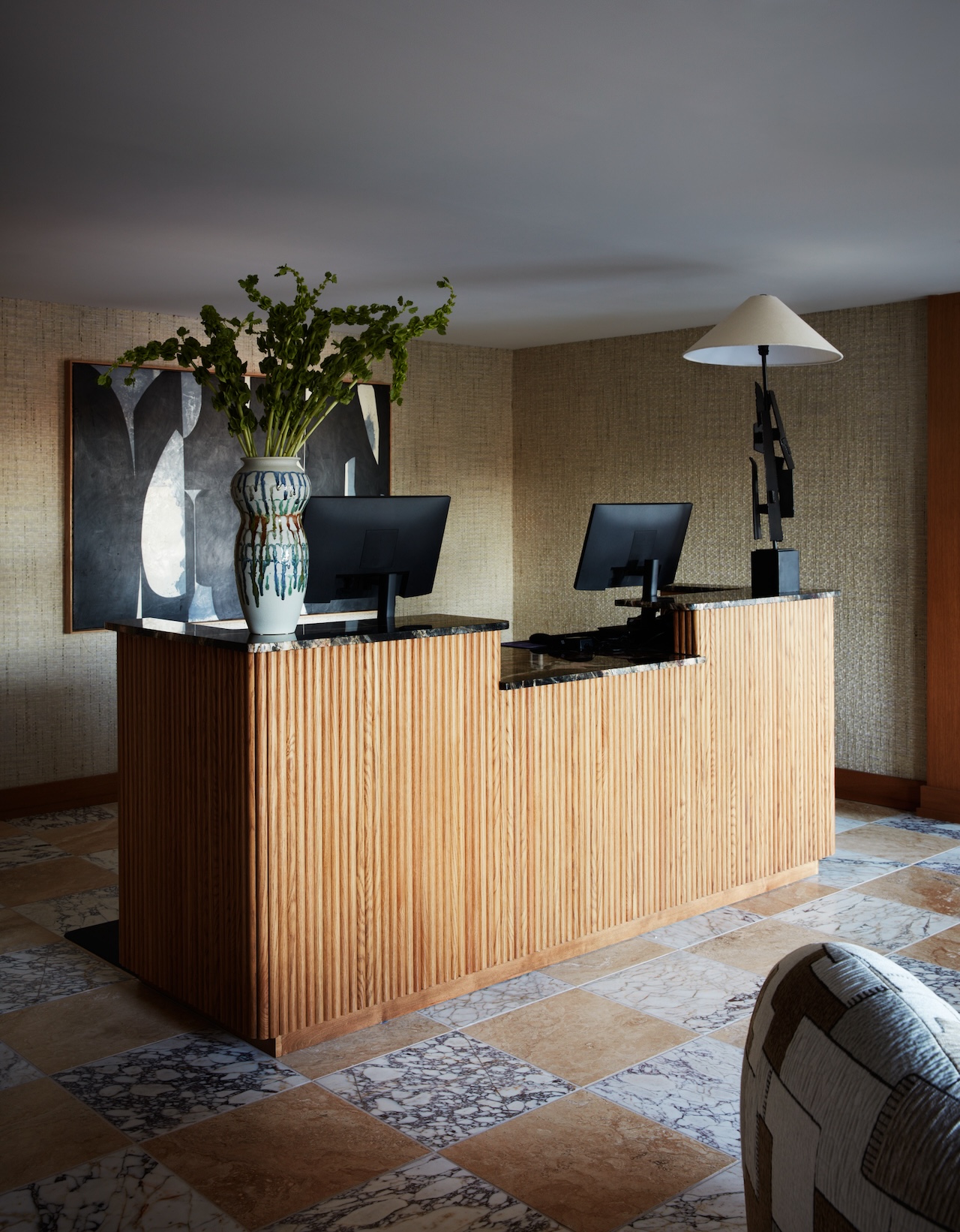 Pictured: The check-in desk at the Delamar Westport with a high-contrast Lisa Bagley on the wall; Photo credit: Tim Lenz