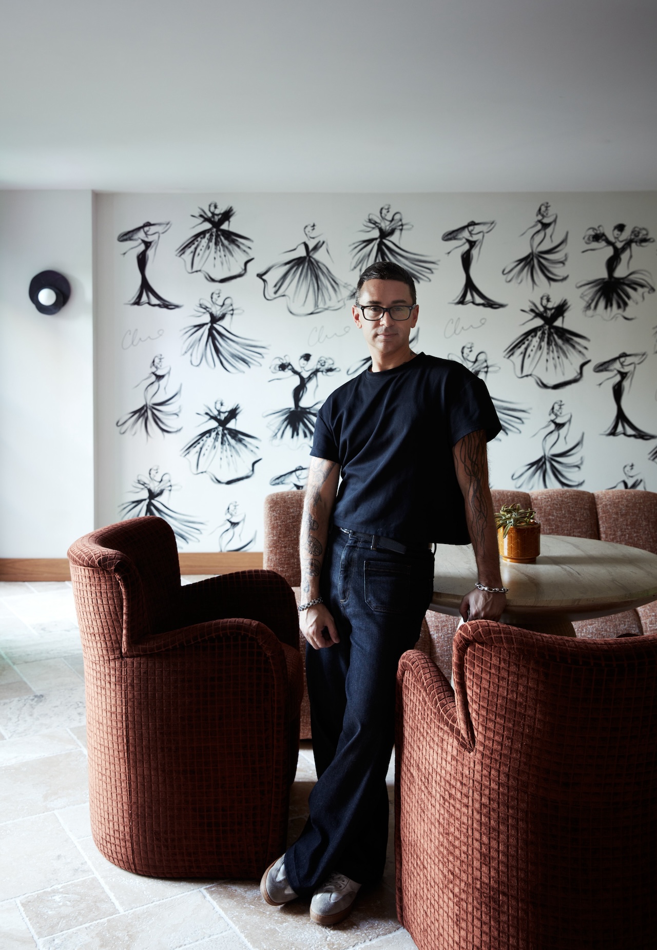 Pictured: Christian Siriano in the lobby of the Delamar Westport with the signature Siriano Sketch Wall behind him; Photo credit: Tim Lenz