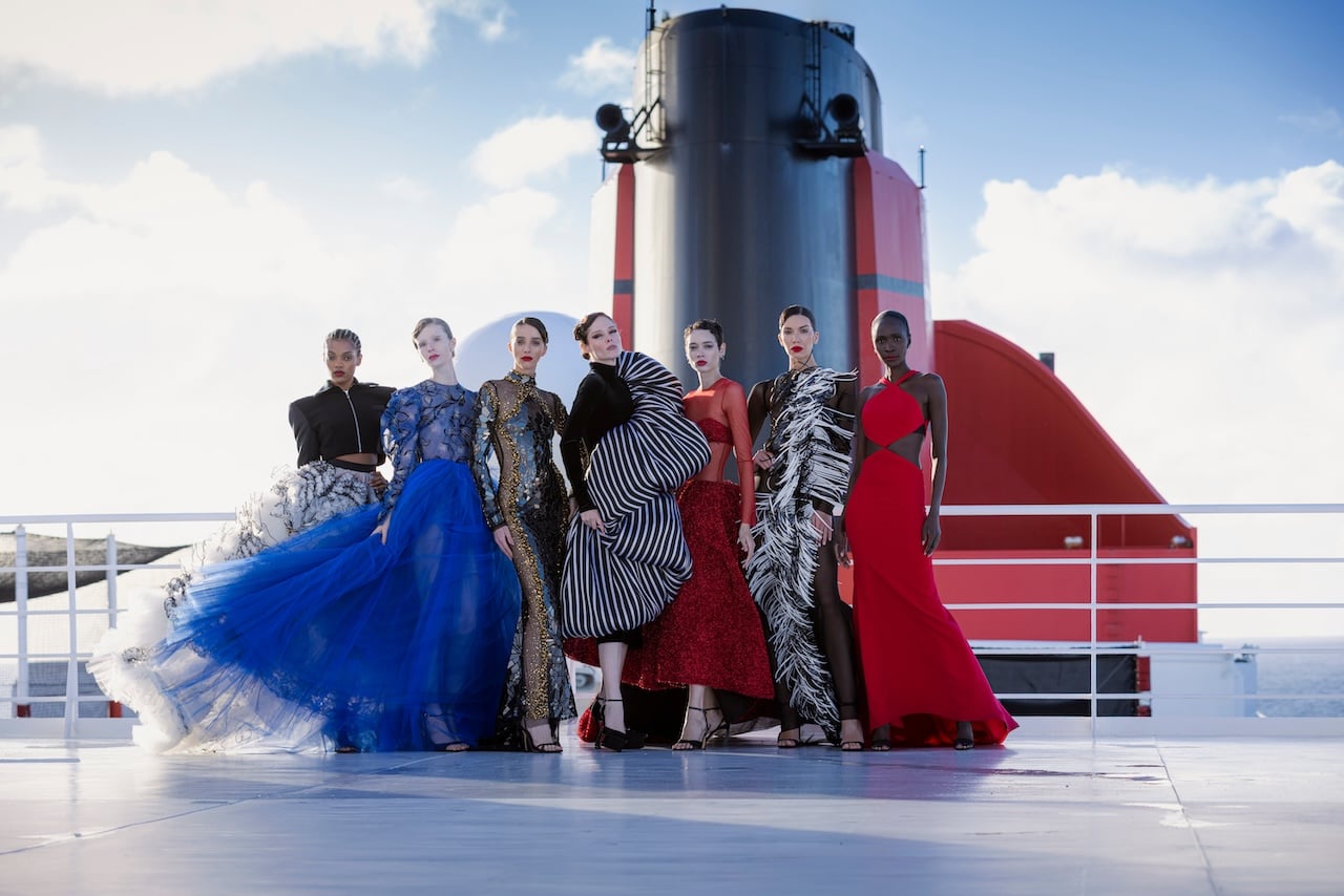 Pictured: Coco Rocha (center) among the models who participated in Cunard’s Transatlantic Fashion Week 2025 with Christian Siriano. All are wearing Siriano; Photo by: Cunard
