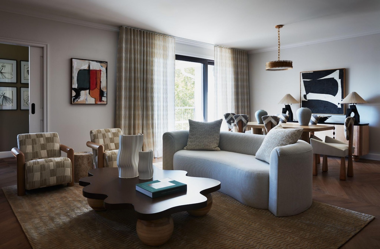 Pictured: Living room and dining area of the Siriano Suite at the Delamar Westport; Artwork: (right) Lisa Bagley, (left) Christian Siriano; Photo credit: Tim Lenz