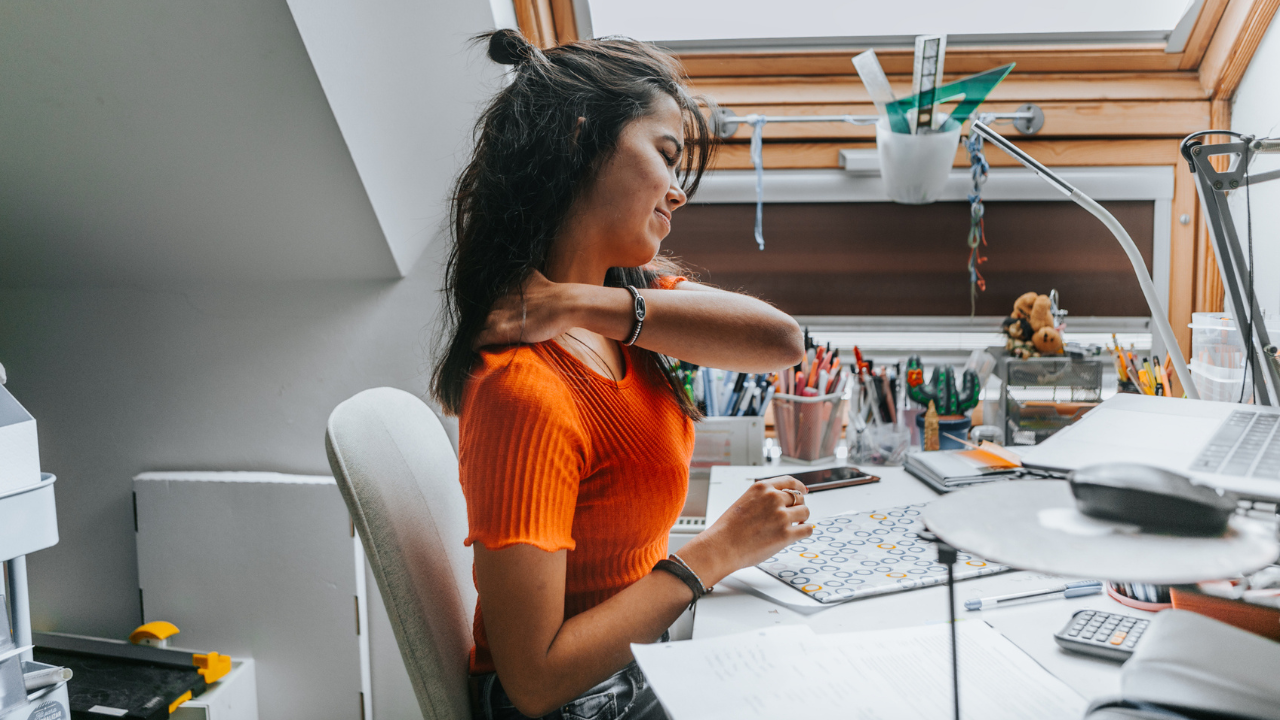 Woman at her desk with back pain