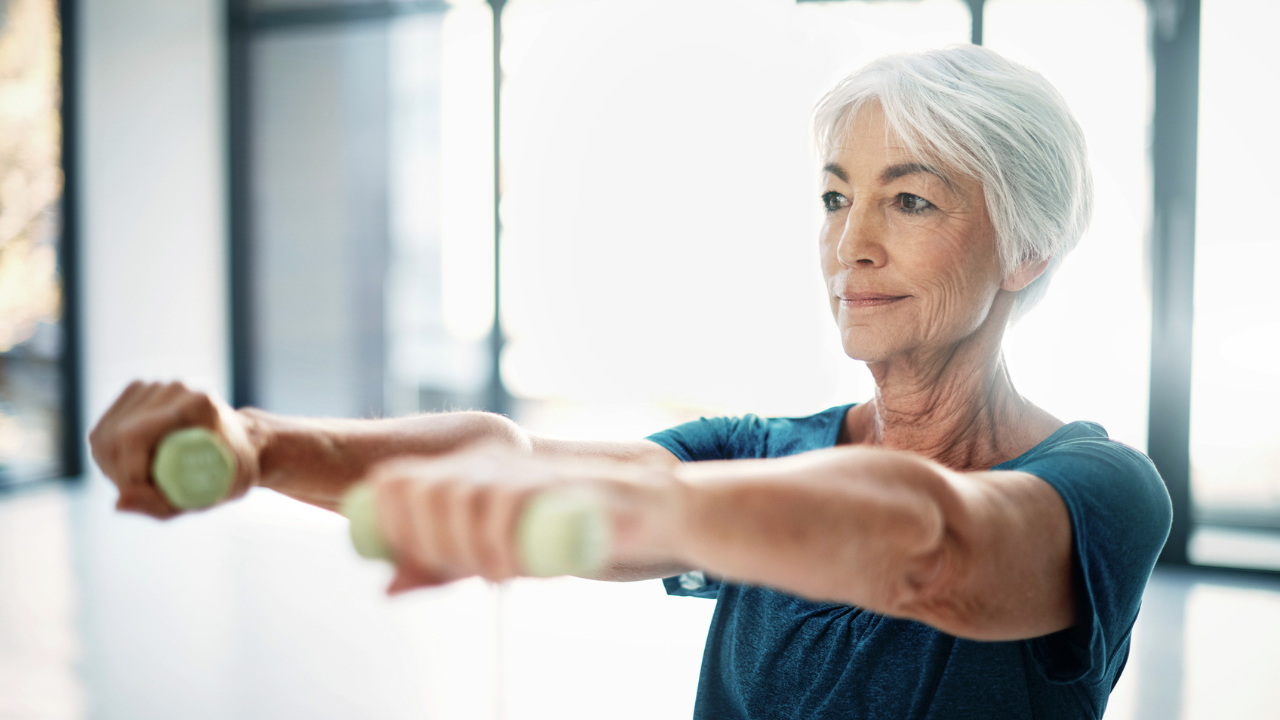 Older woman in the gym with dumbbells