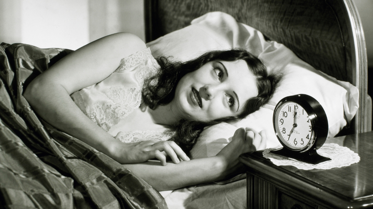 Woman with alarm clock