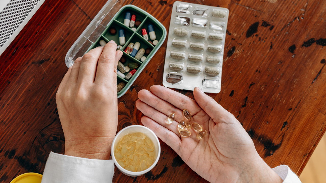 Hands holding different supplements and pills
