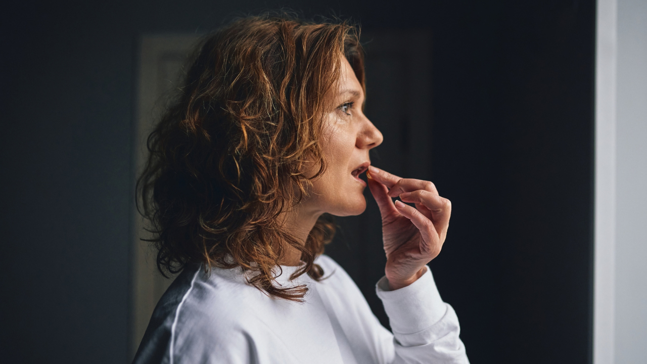 Woman talking a supplement
