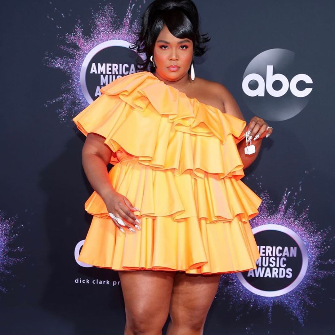 Lizzo brings the world's smallest handbag to American Music Awards